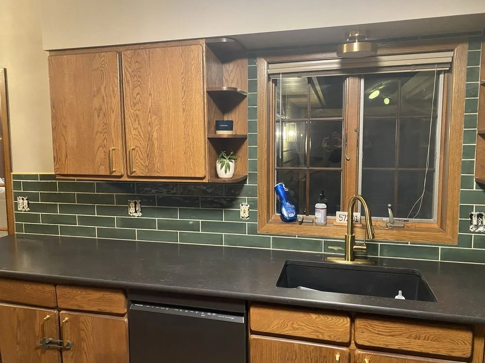 Elegant kitchen with dark wood cabinets and white subway ceramic tile backsplash with under-cabinet lighting