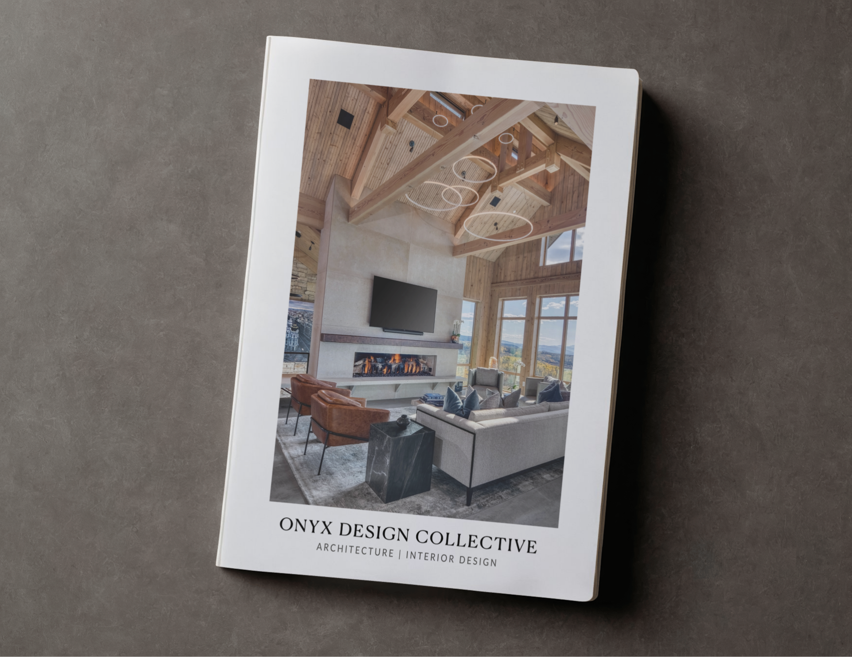 A brochure from ONYX DESIGN COLLECTIVE featuring an interior living room with high wooden ceilings, large windows, a fireplace, a wall-mounted TV, and modern furniture including sofas and chairs.