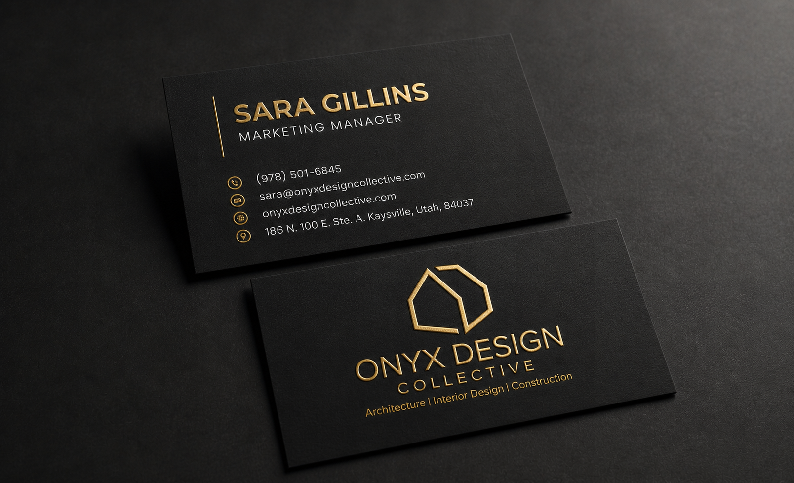 Black business cards with gold foil text for Onyx Design Collective, featuring logo, contact information, and services including architecture, interior design, and construction.