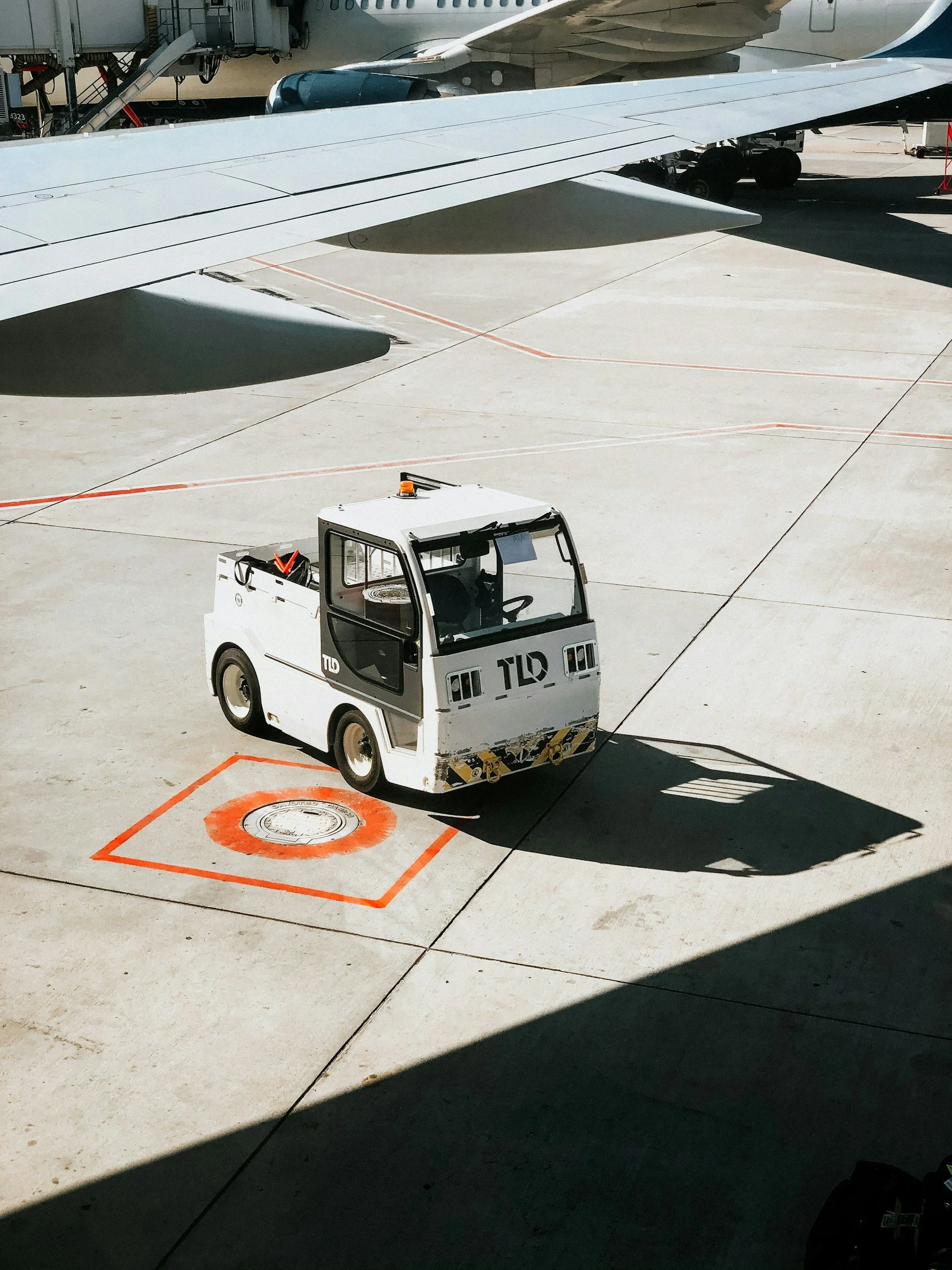 A small white truck with a short bed and tall cab