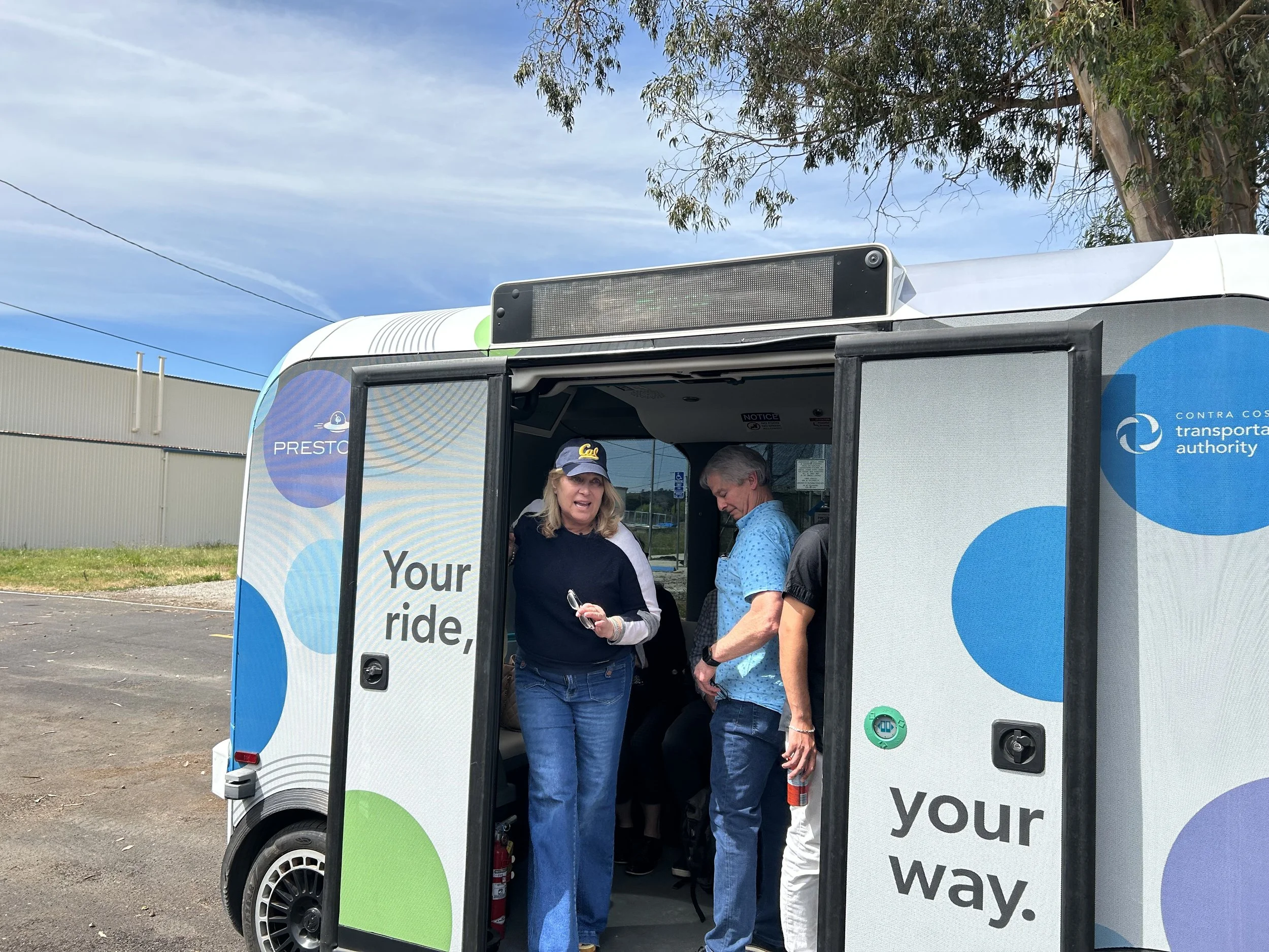 Seval Oz and a man in a blue shirt inside an autonomous vehicle