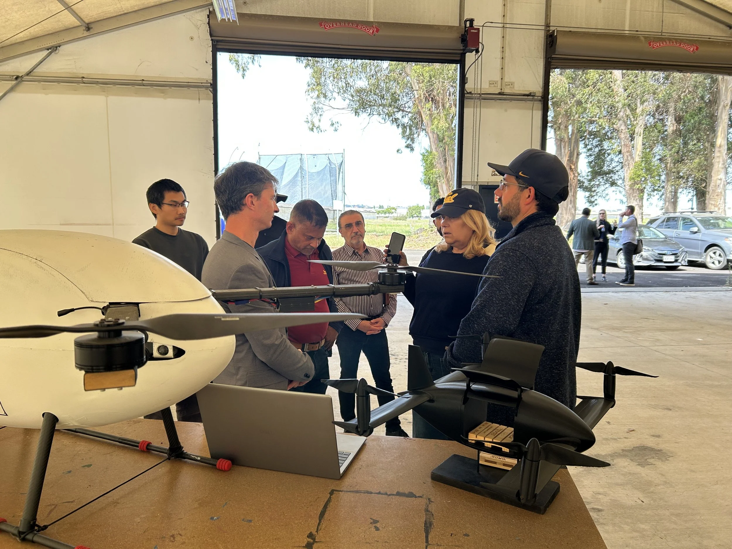 A group of people standing around drones