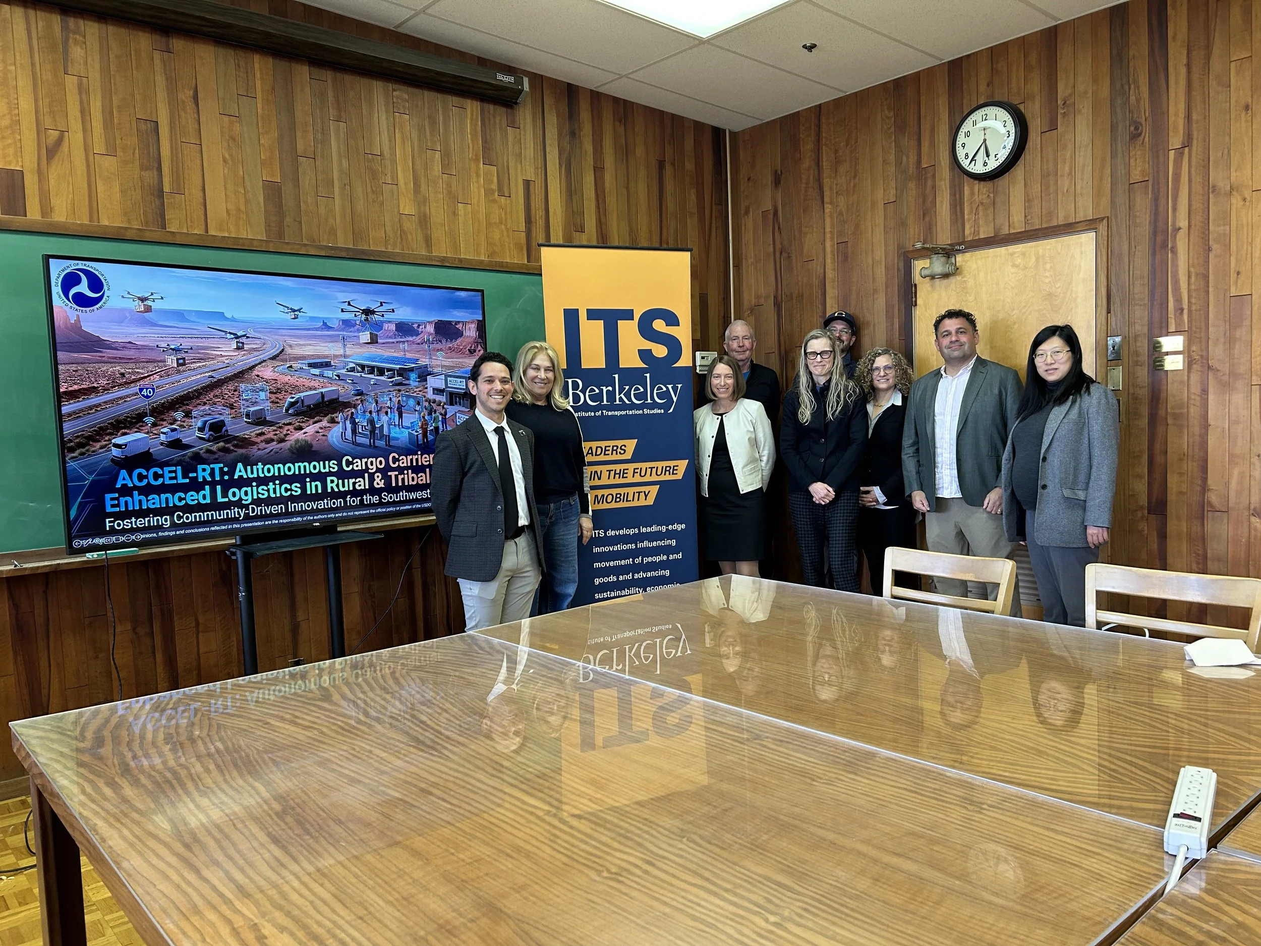 Attendees behind a boardroom table