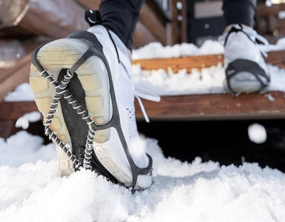 Ice traction grips attached to shoes for walking on snow and icy surfaces.