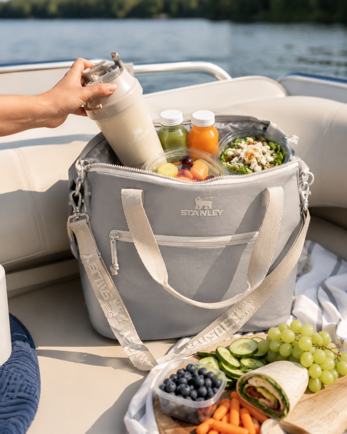 Small insulated cooler bag packed with drinks, fruit, salad and snacks.