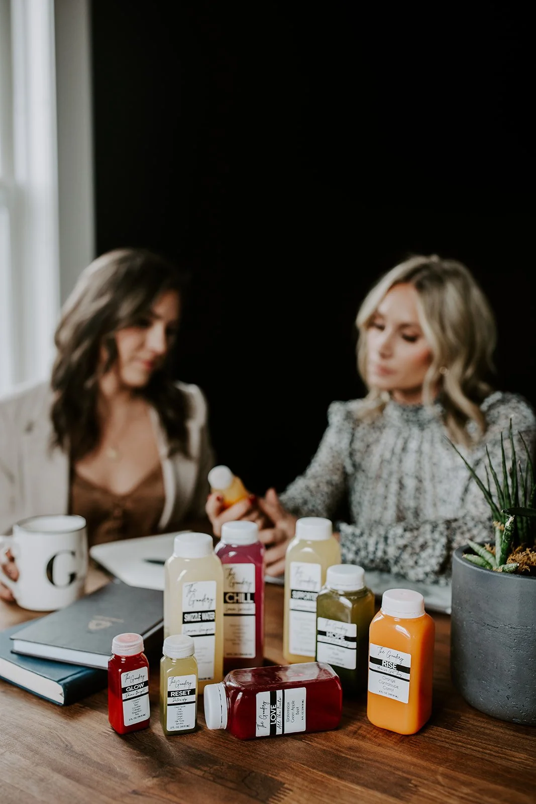 The Goodery Co. founders seated together with wellness products and drinks