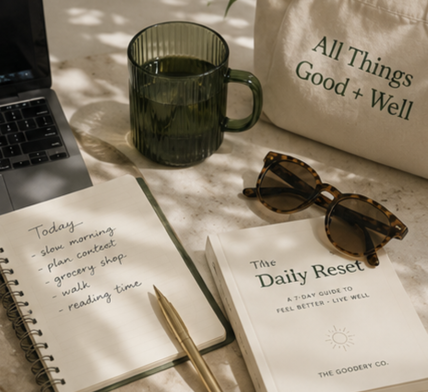 The Goodery Co. media and press workspace with journal, laptop, coffee and wellness lifestyle items