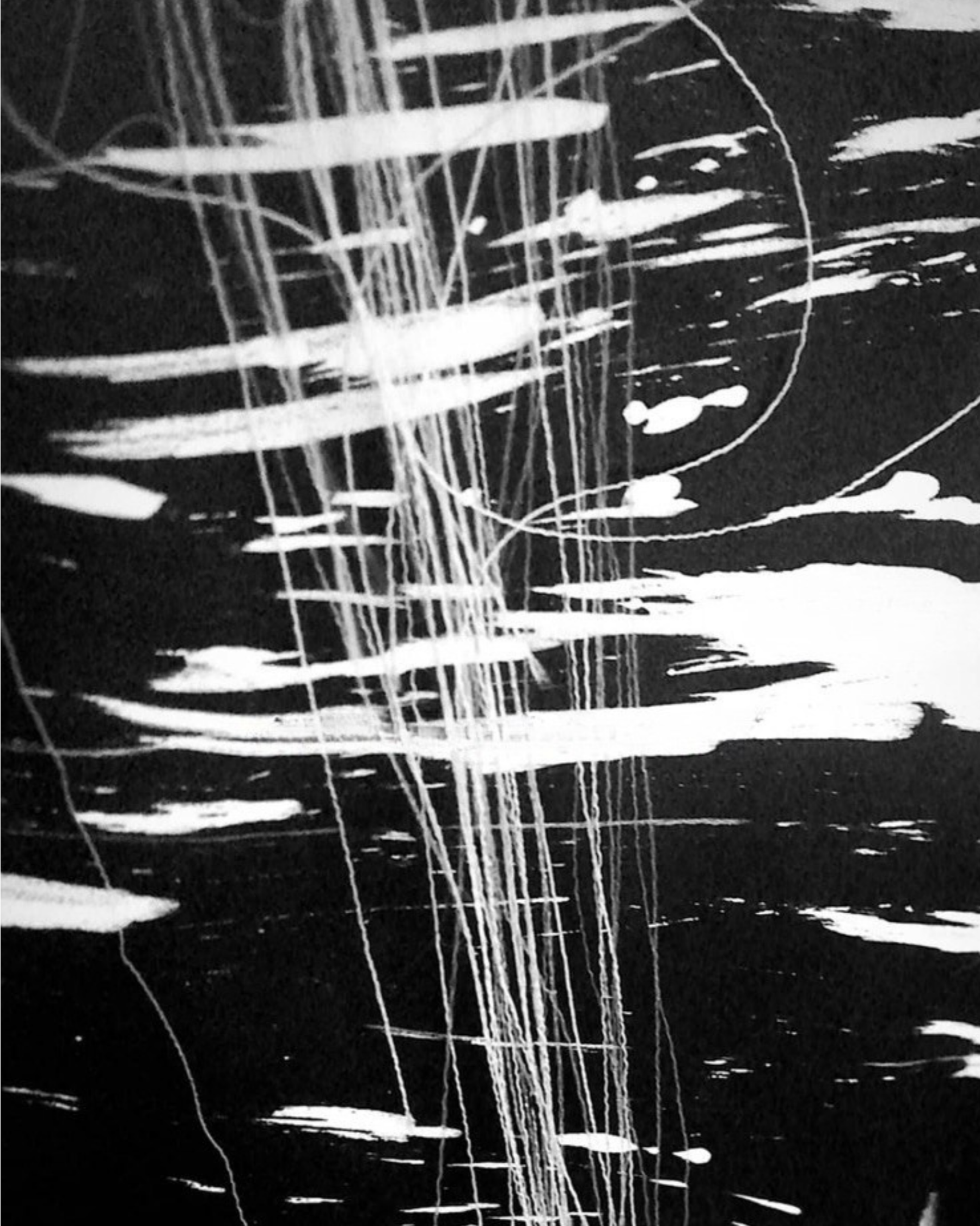 Black and white abstract painting with white streaks and splatters on a black background.