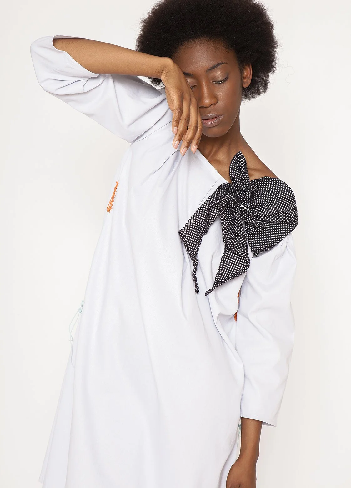 Zara Saberi — Close-up of handcrafted appliqué and embroidered textile details.