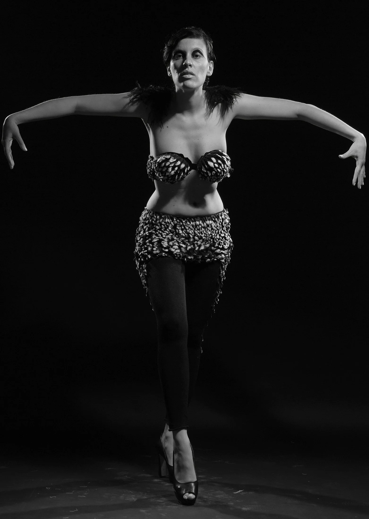 Full-length view of the Beneath the Surface garment by Zara Saberi, revealing a white interior beneath its black exterior through experimental textile design.