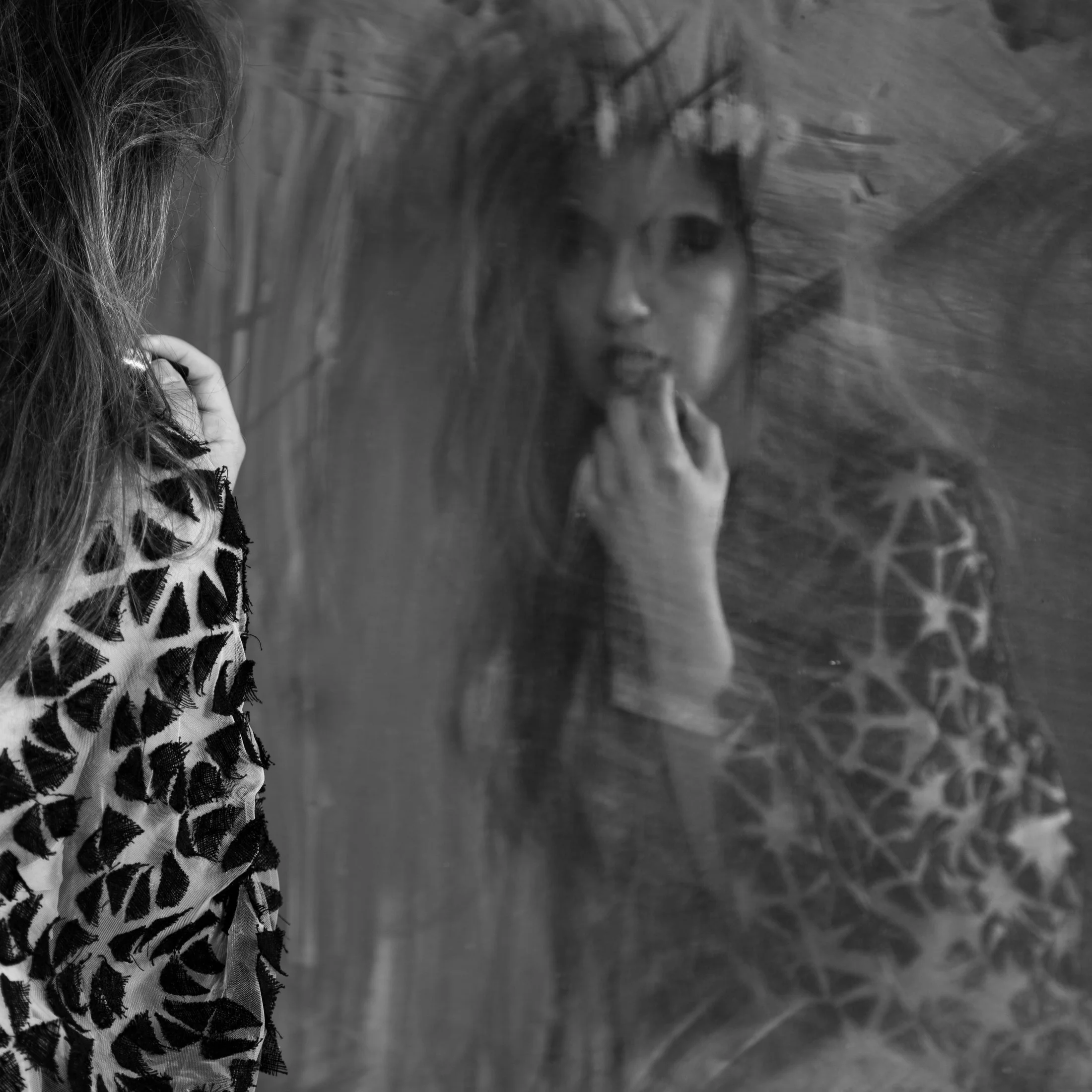 Zara Saberi — Layered textile composition combining recycled fabrics into a geometric fashion structure.