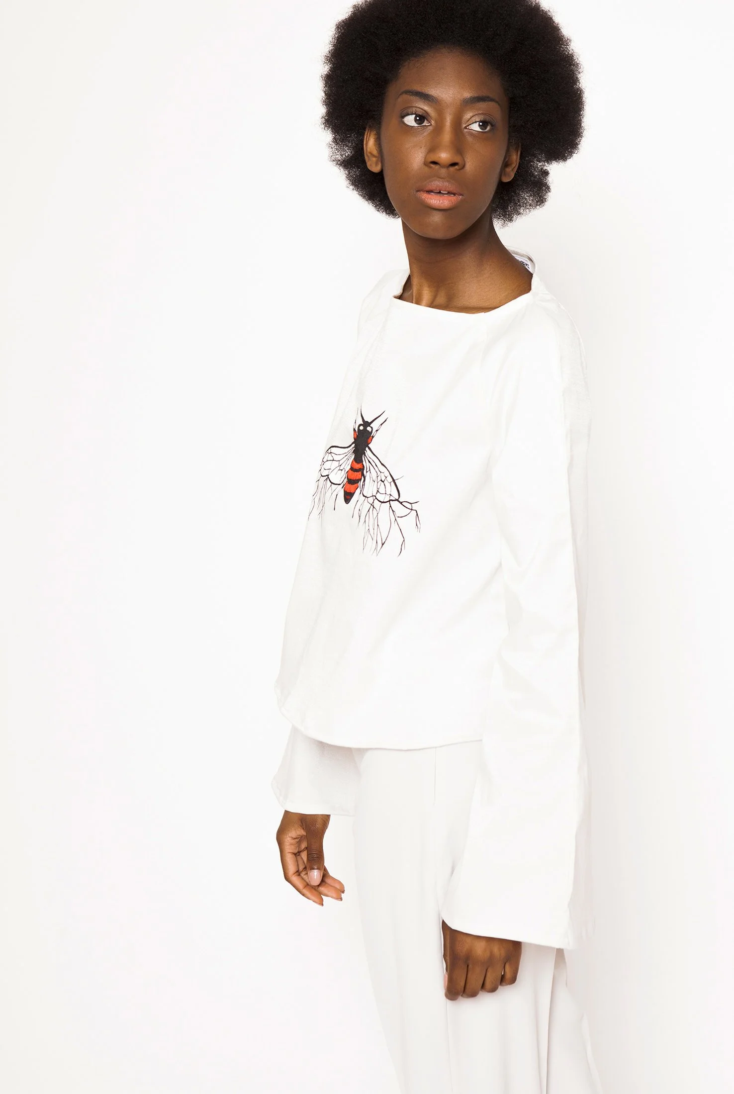 Zara Saberi — Garment detail combining guipure lace with hand-painted fabric.