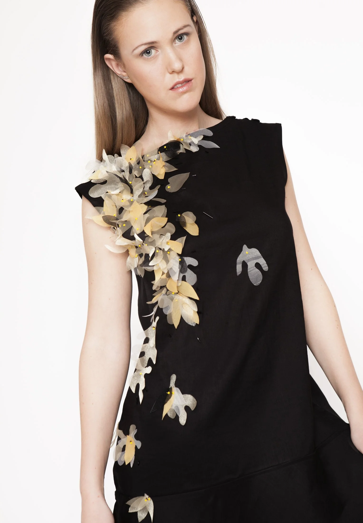 Zara Saberi — Wearable art garment revealing layered handcrafted textile details.
