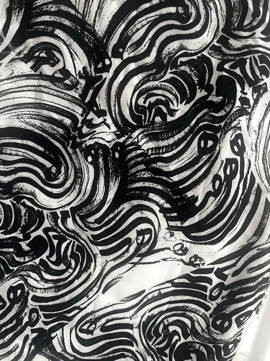 Abstract black and white striped pattern with irregular, swirling lines.