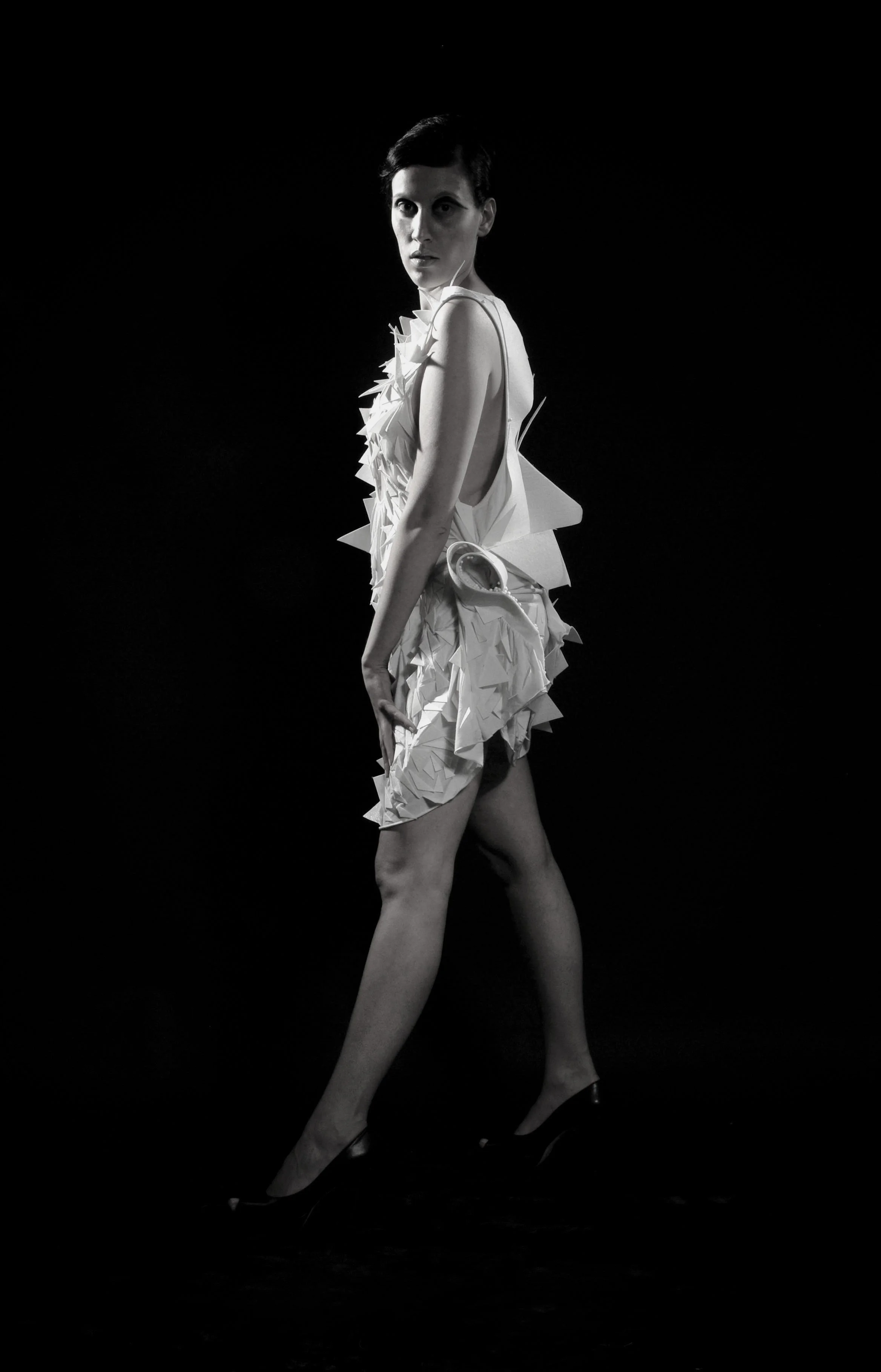 Zara Saberi — Wearable artwork from the Triangles project investigating balance and geometric form through handcrafted recycled textiles in Italy.