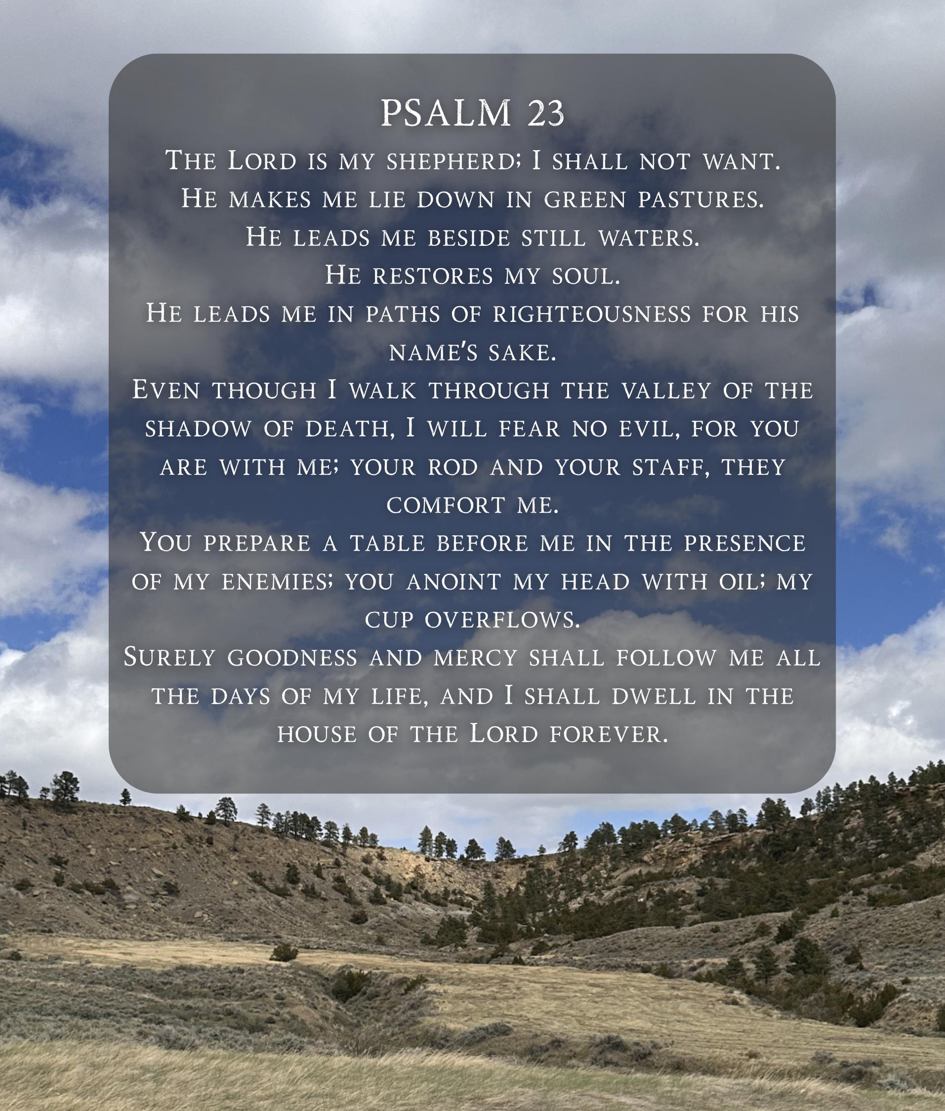 A scenic view of a hilly landscape with sparse trees and grass, with a cloudy sky in the background. Overlaid on the sky is a semi-transparent panel with Psalm 23 written in white text, describing the Lord as a shepherd who guides and restores the soul.