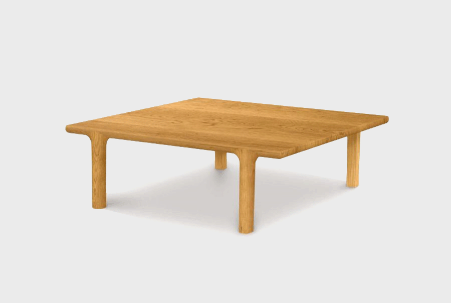 A low wooden table with a rectangular top and four sturdy legs, made of light-colored wood.