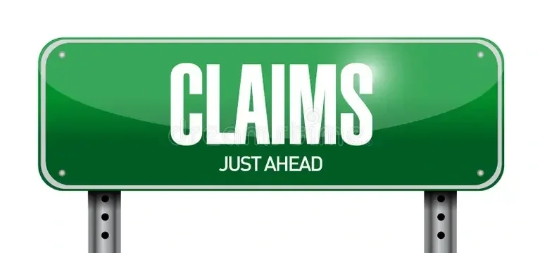 Green road sign with the word 'CLAIMS' and 'JUST AHEAD' written below.