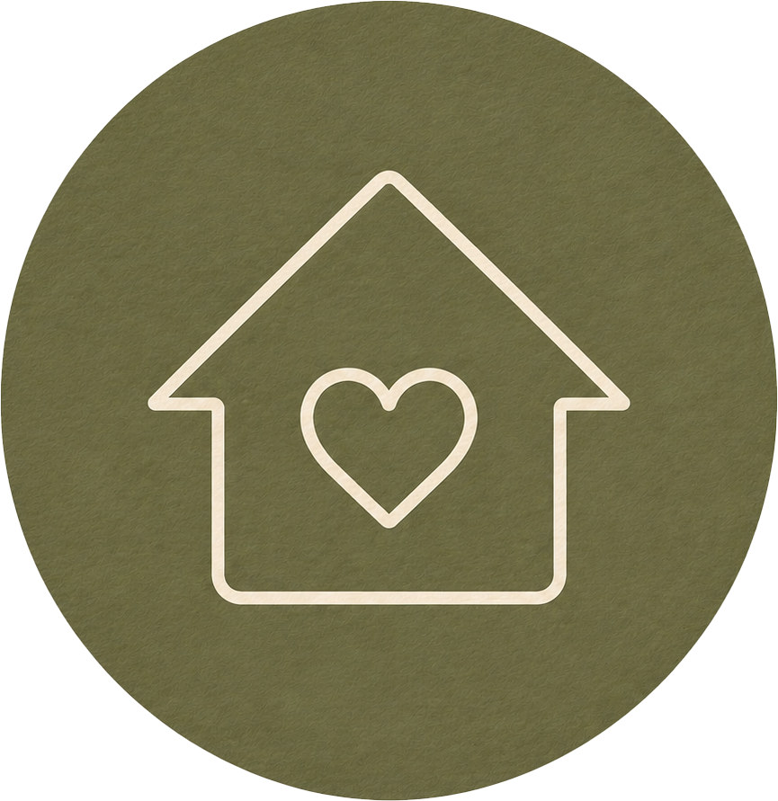 An icon of a house with a heart inside it, outlined in white on a round, olive-green background.