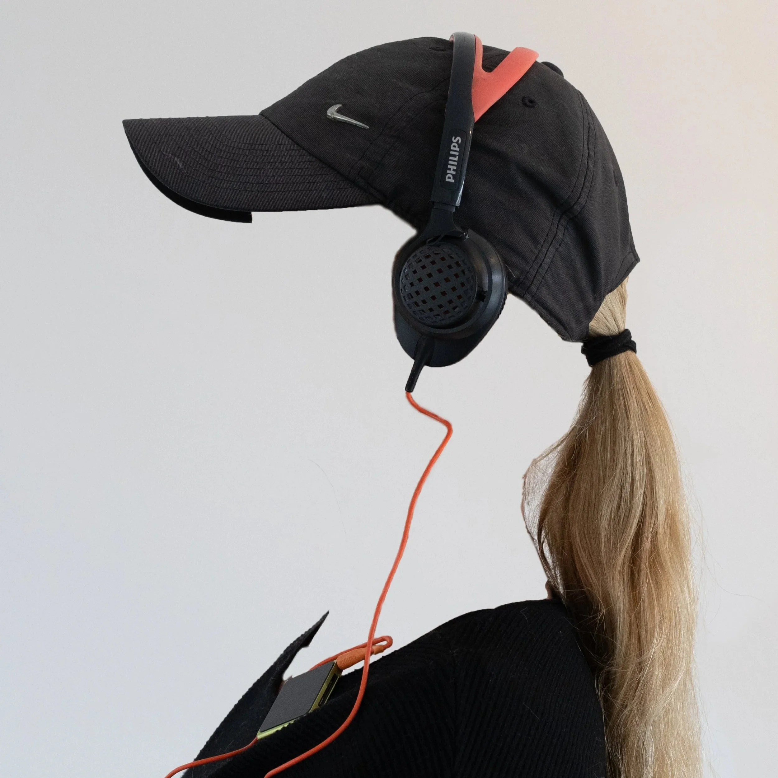 Invisible person wearing cap and headphones without visible face — by ROEL | WILLEM