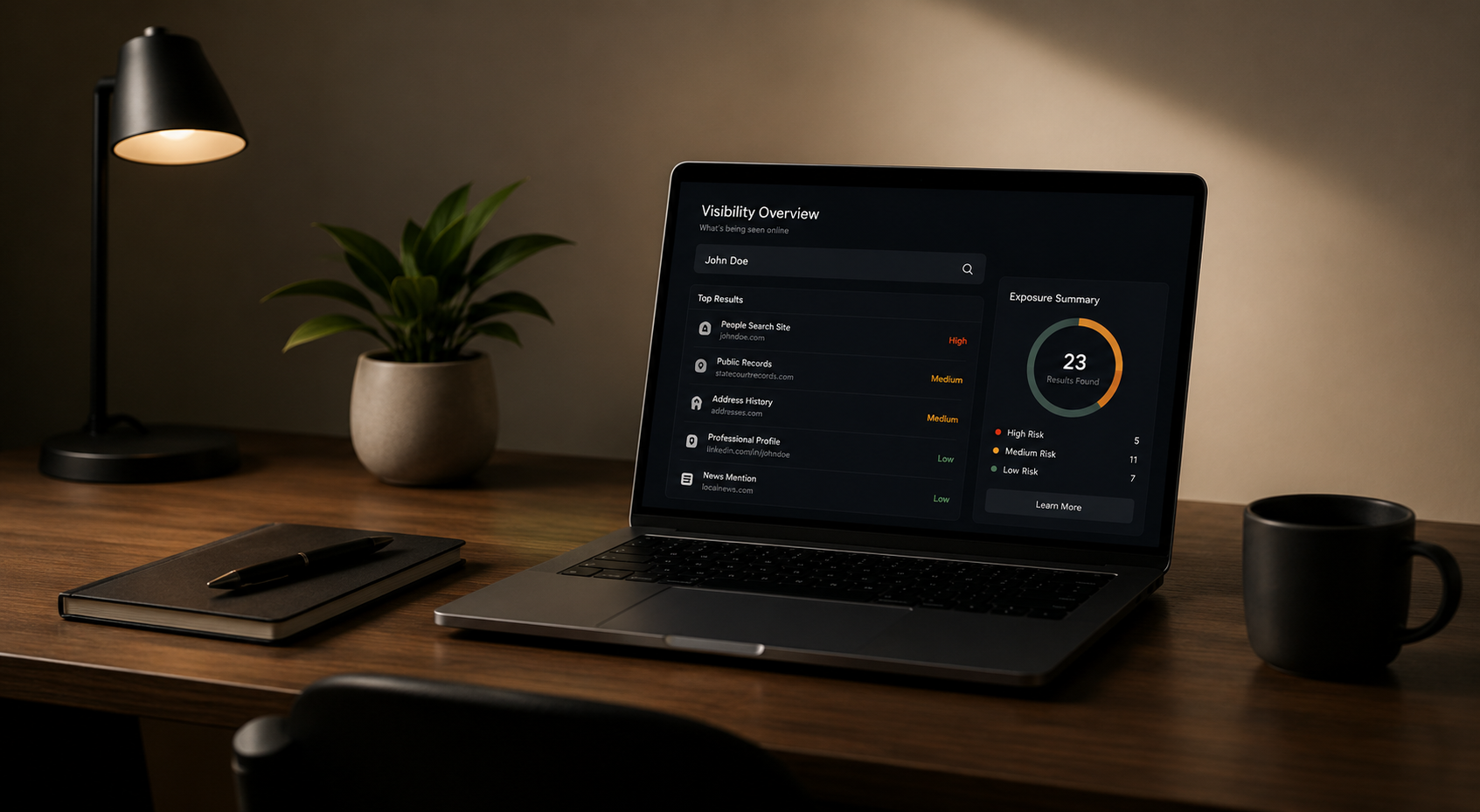 Modern workspace with laptop displaying online visibility and privacy monitoring dashboard.