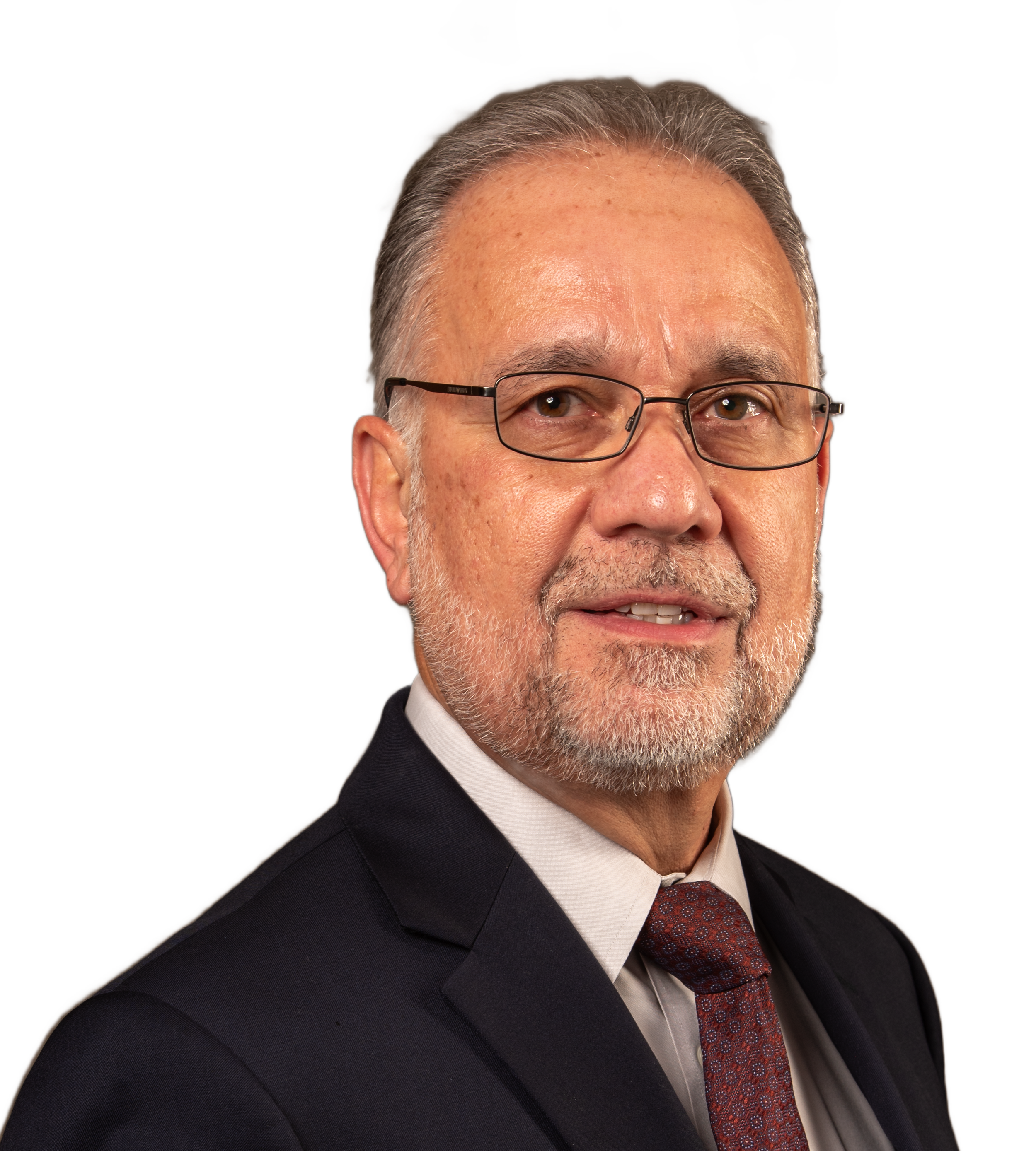 Close-up of an Tim Silva in a business suit, white shirt, and patterned red tie, smiling slightly.