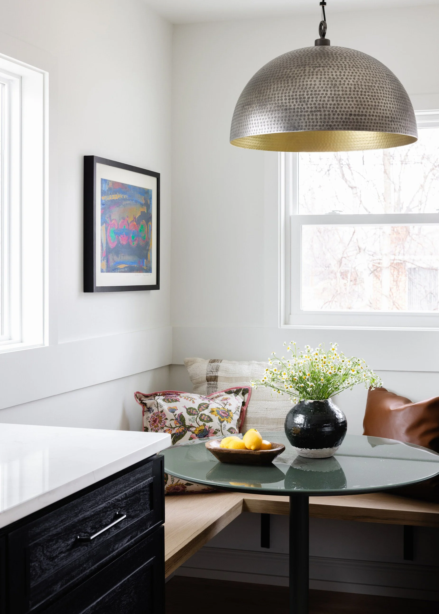 Home renovation with kitchen nook and circular table, oversized pendant light