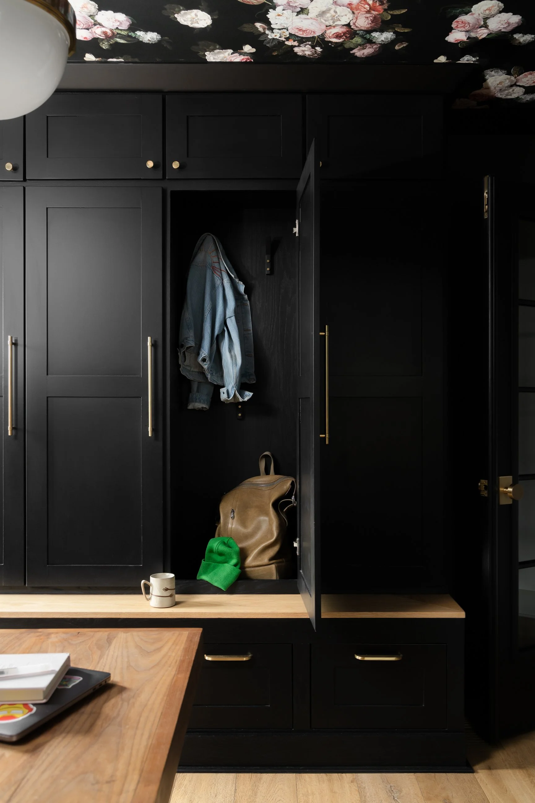 Drop station with mood - floral ceiling wallpaper and dark cabinetry 