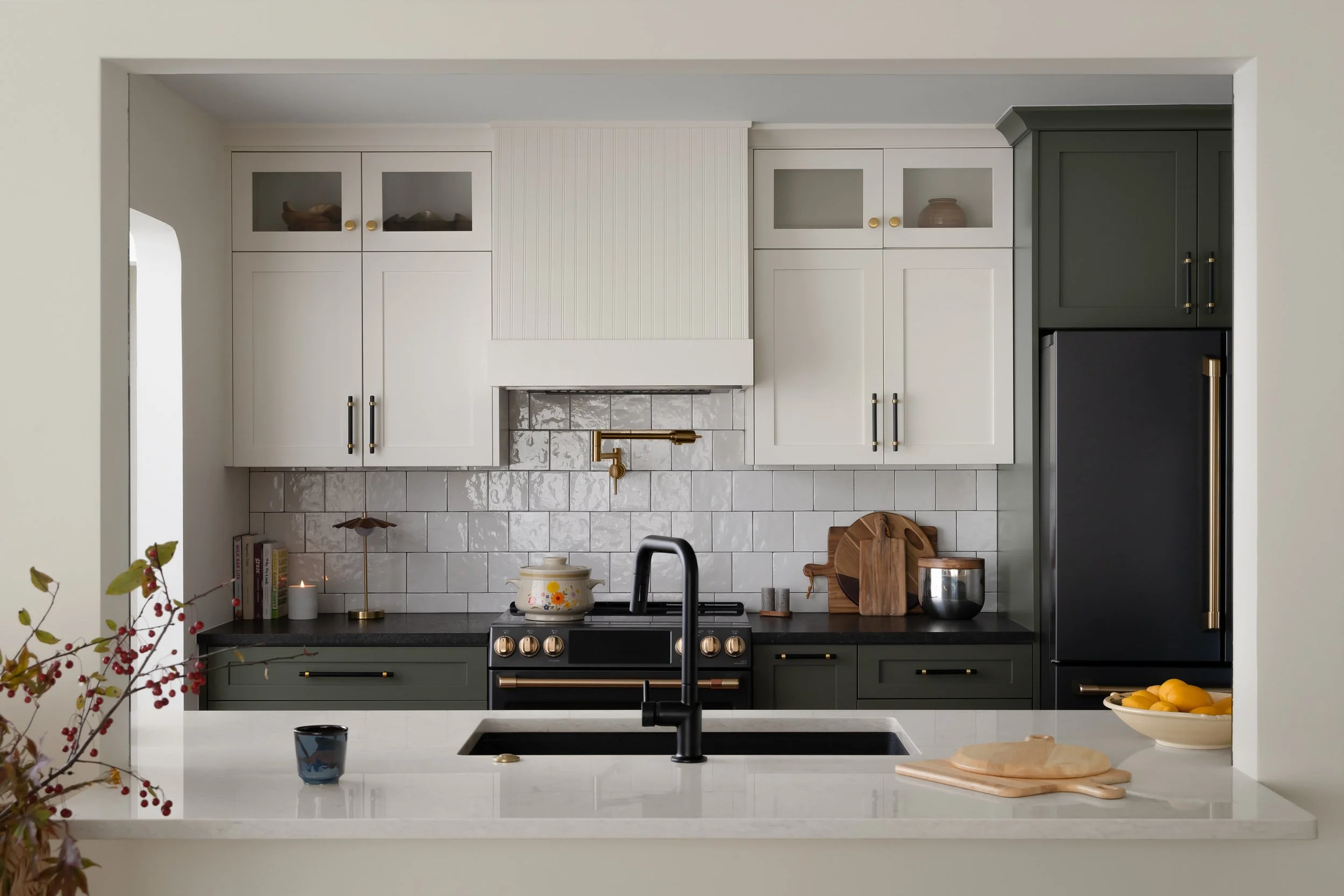Modern classic design with light upper cabinets and black accents