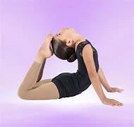 A woman performing a yoga pose on a purple mat with a light purple background.