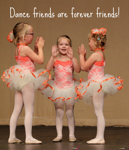 Three young girls dressed in pink and orange tutus performing a dance on stage with the words "Dance friends are forever friends!" written above them.