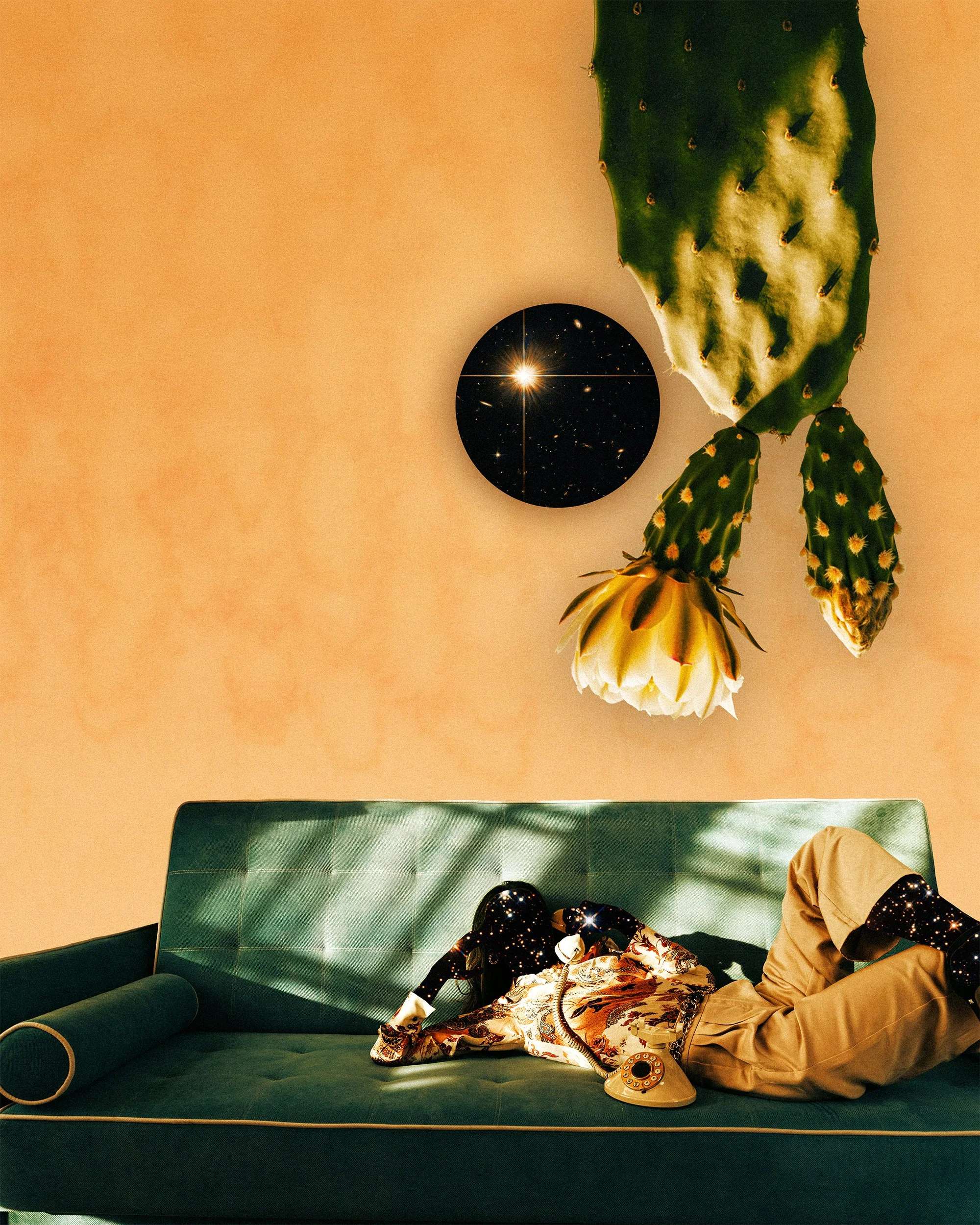 A person wearing a patterned shirt and beige pants is lying on a green couch. The person's head is off the edge of the couch, and they are holding a vintage rotary phone. Above the couch, there is a large green cactus and a round mirror reflecting the starry sky and galaxy. The background walls are peach-colored.