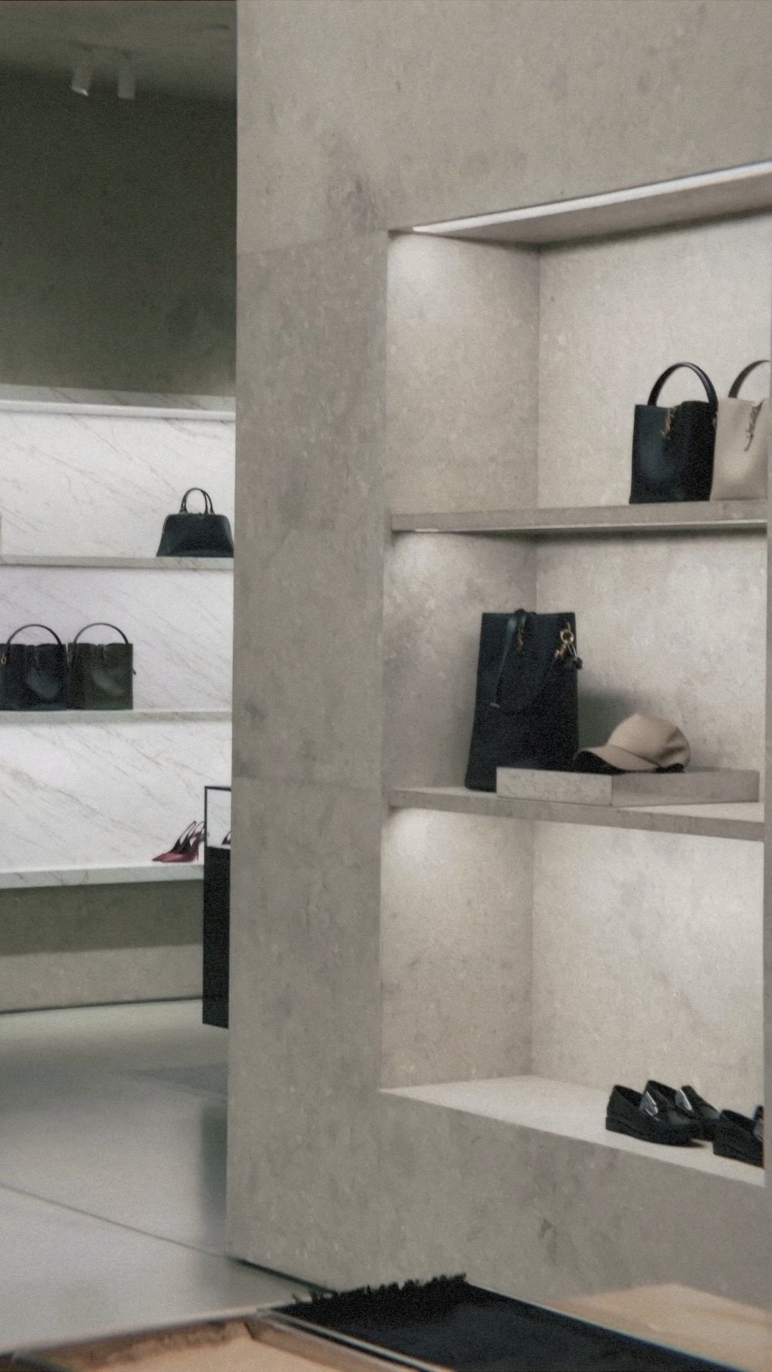 Display shelves with handbags, a hat, and shoes in a retail store.