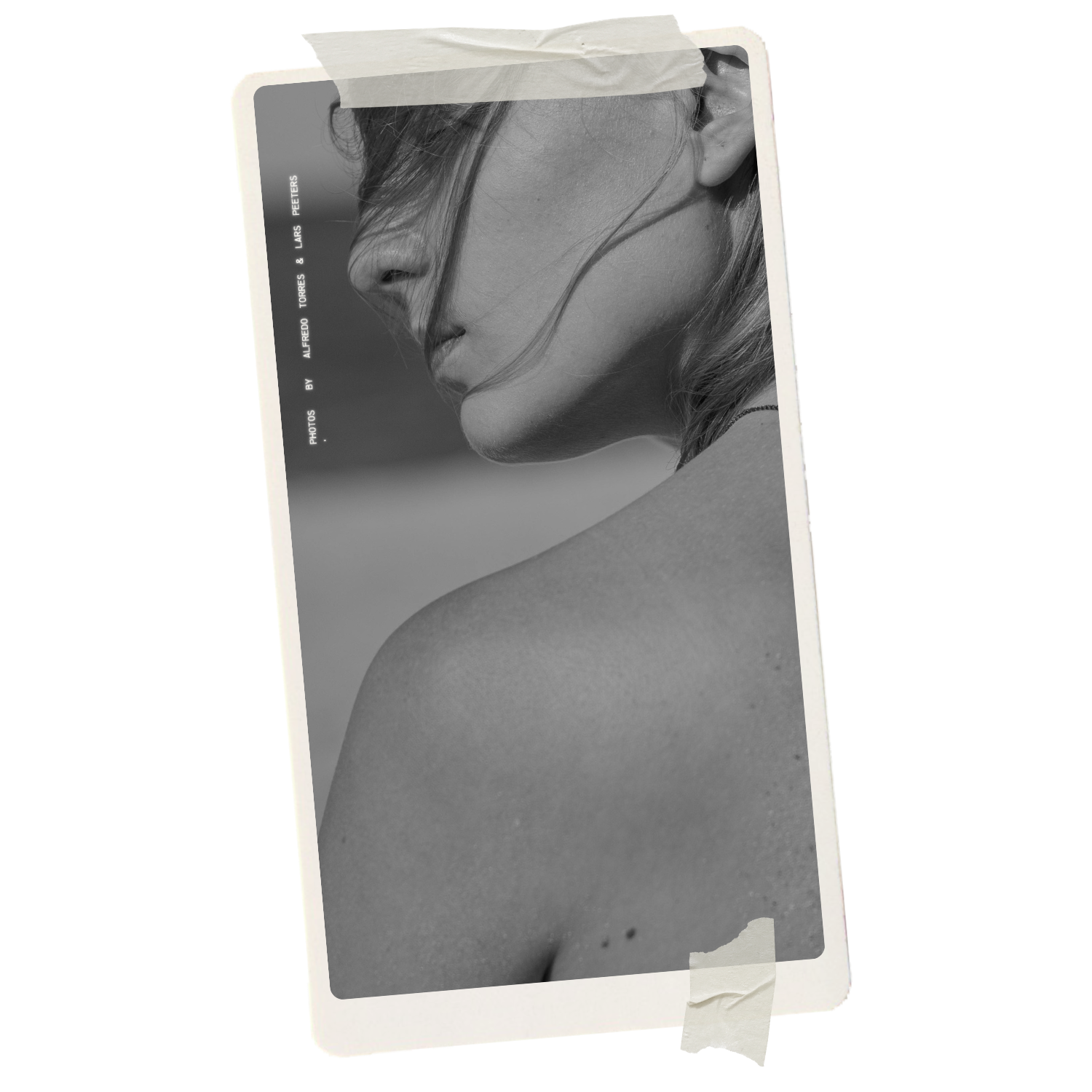 Black and white photograph of a woman's face in profile, partially obscured by her hair, with a focus on her nose, lips, and jawline, displayed on a Polaroid-style photo taped to a surface.
