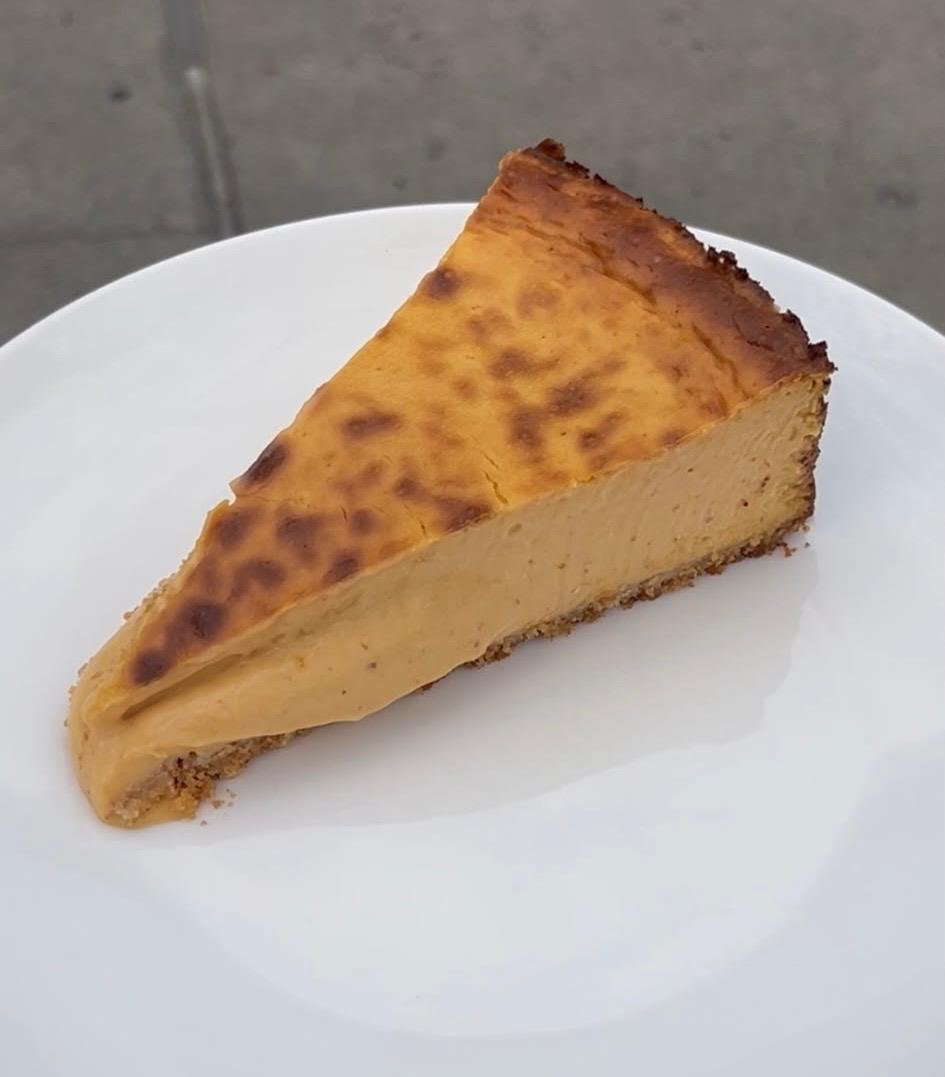 Pumpkin Basque Cheesecake slice viewed from above on a white plate