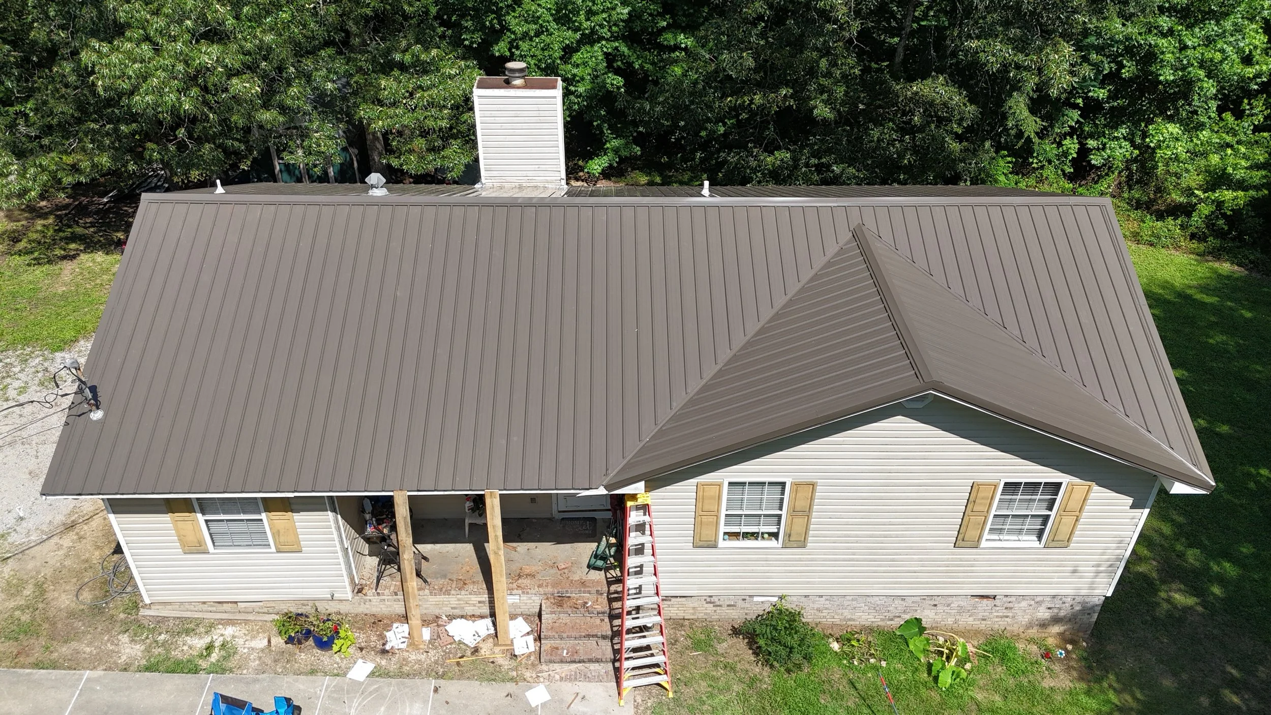 An aerial view of a house with a metal roof that Revolution Roofing installed. 