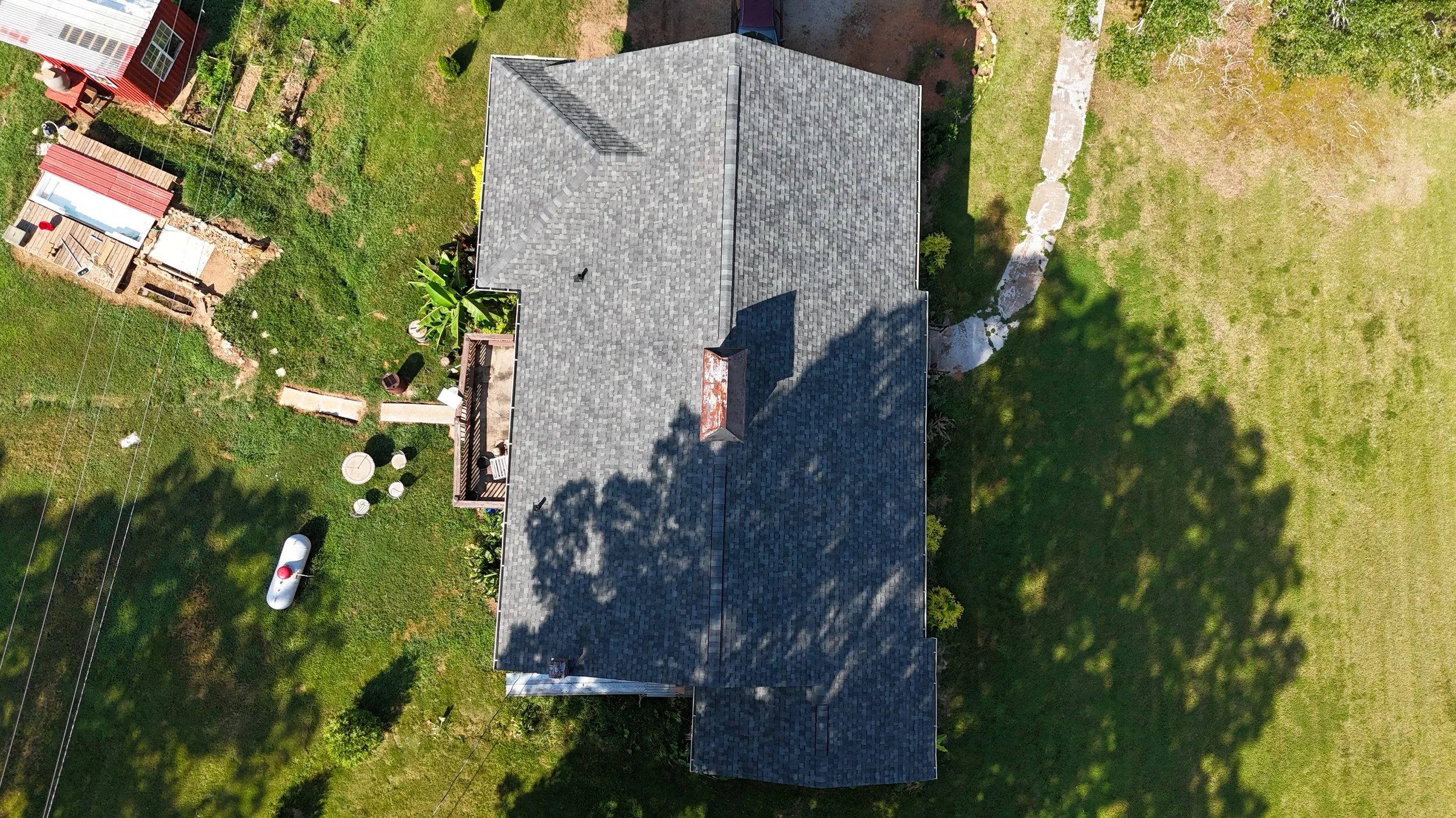 Revolution Roofing Asphalt Shingle roof in woodland