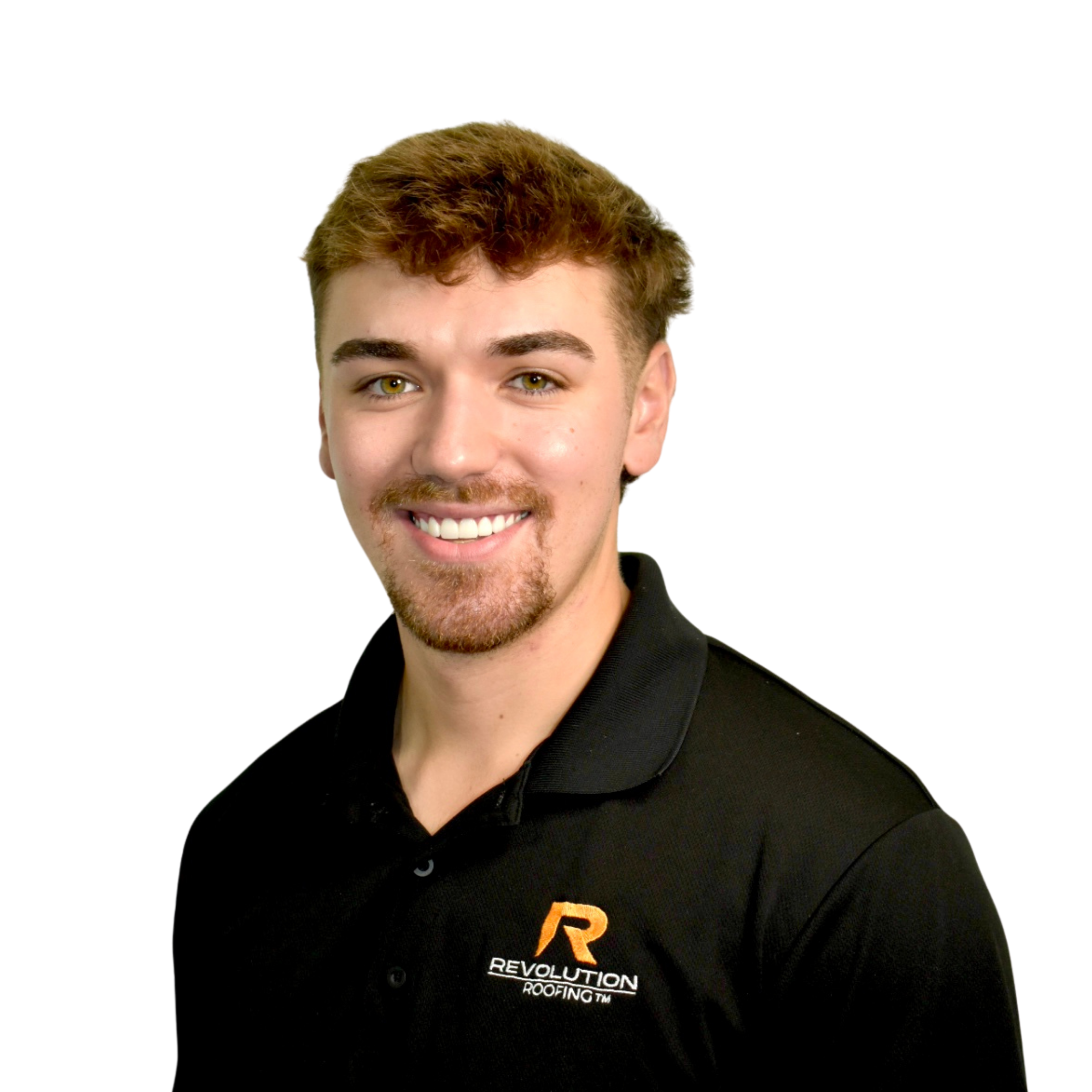 Close-up of a young man with light brown hair, blue eyes, and a friendly smile wearing a white shirt with an orange and black logo on the chest, standing against a white background.