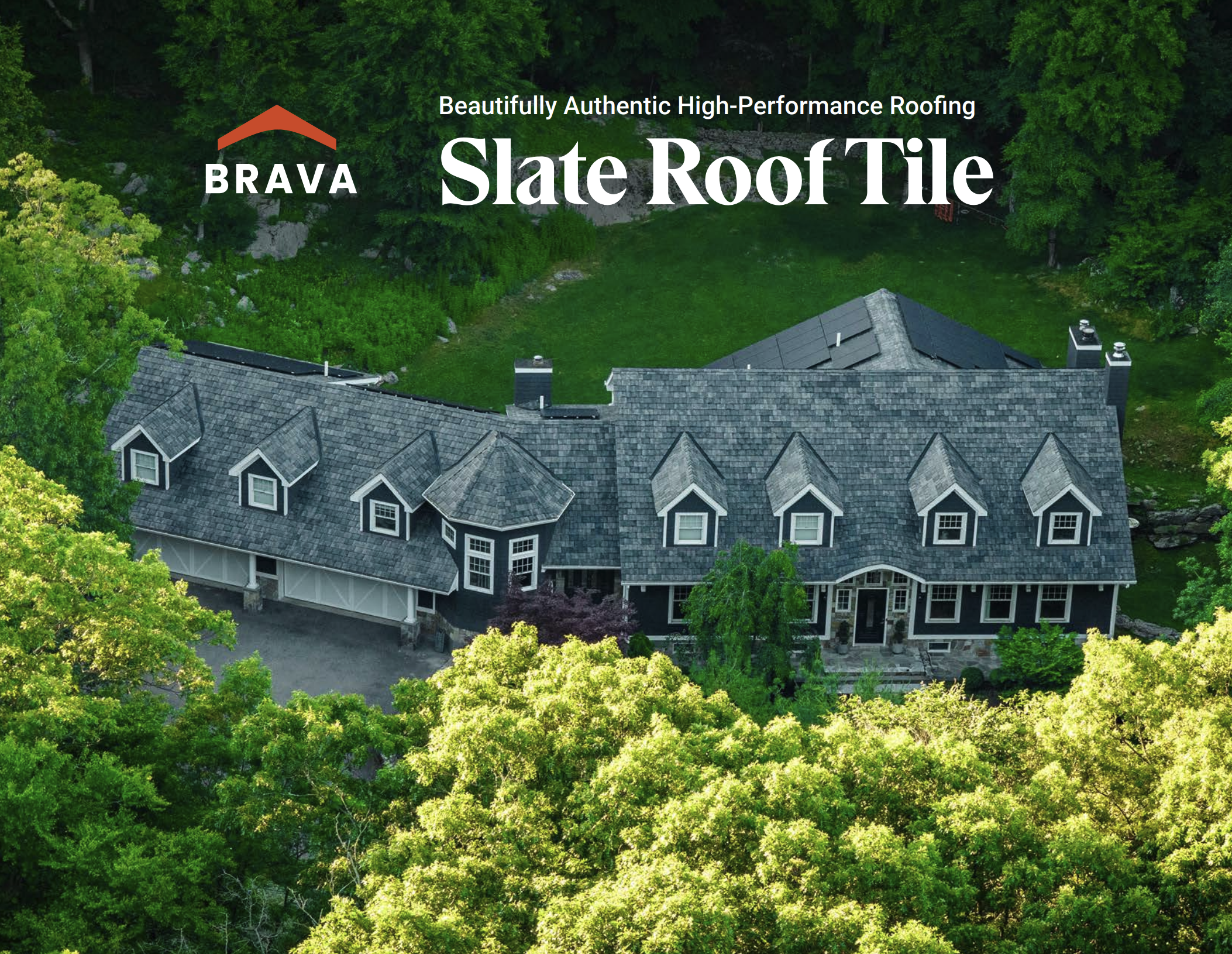 A house with a gray roof surrounded by lush green trees and foliage.