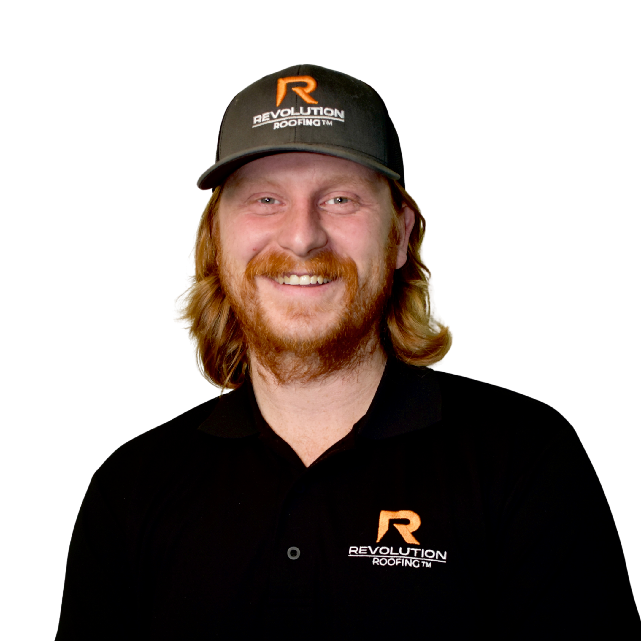 Close-up of a person wearing a black baseball cap with an orange and white logo reading 'Revolution Roofing'. The person's face is smiling, showing their teeth and red hair.