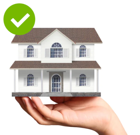 A hand holding a small model of a white house with brown roof and multiple windows, with a green checkmark in a circle above it.