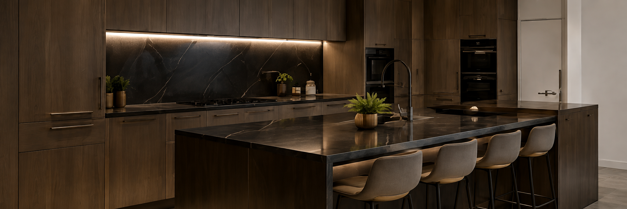 Bespoke walnut kitchen with a black marble splashback, matching island and integrated cabinetry