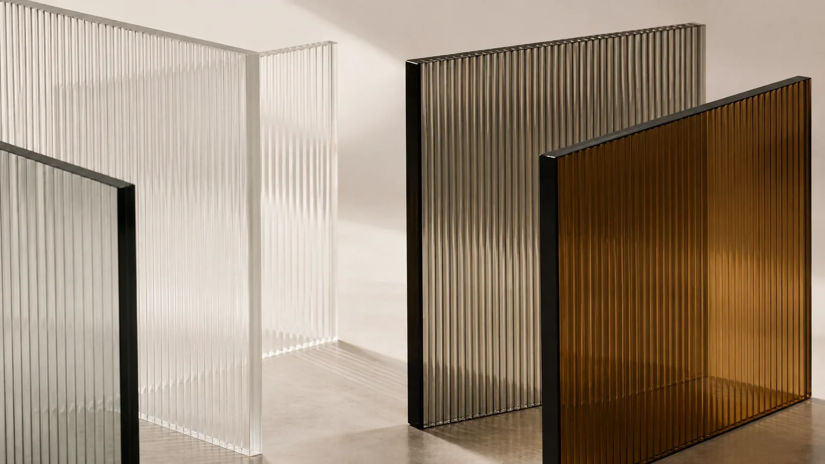 Clear, fluted, smoked and bronze architectural glass samples displayed in a material studio