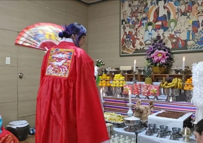 Authentic Mudang ritual altar displaying traditional Korean ceremonial offerings for spiritual healing, protection, and ancestral blessings.