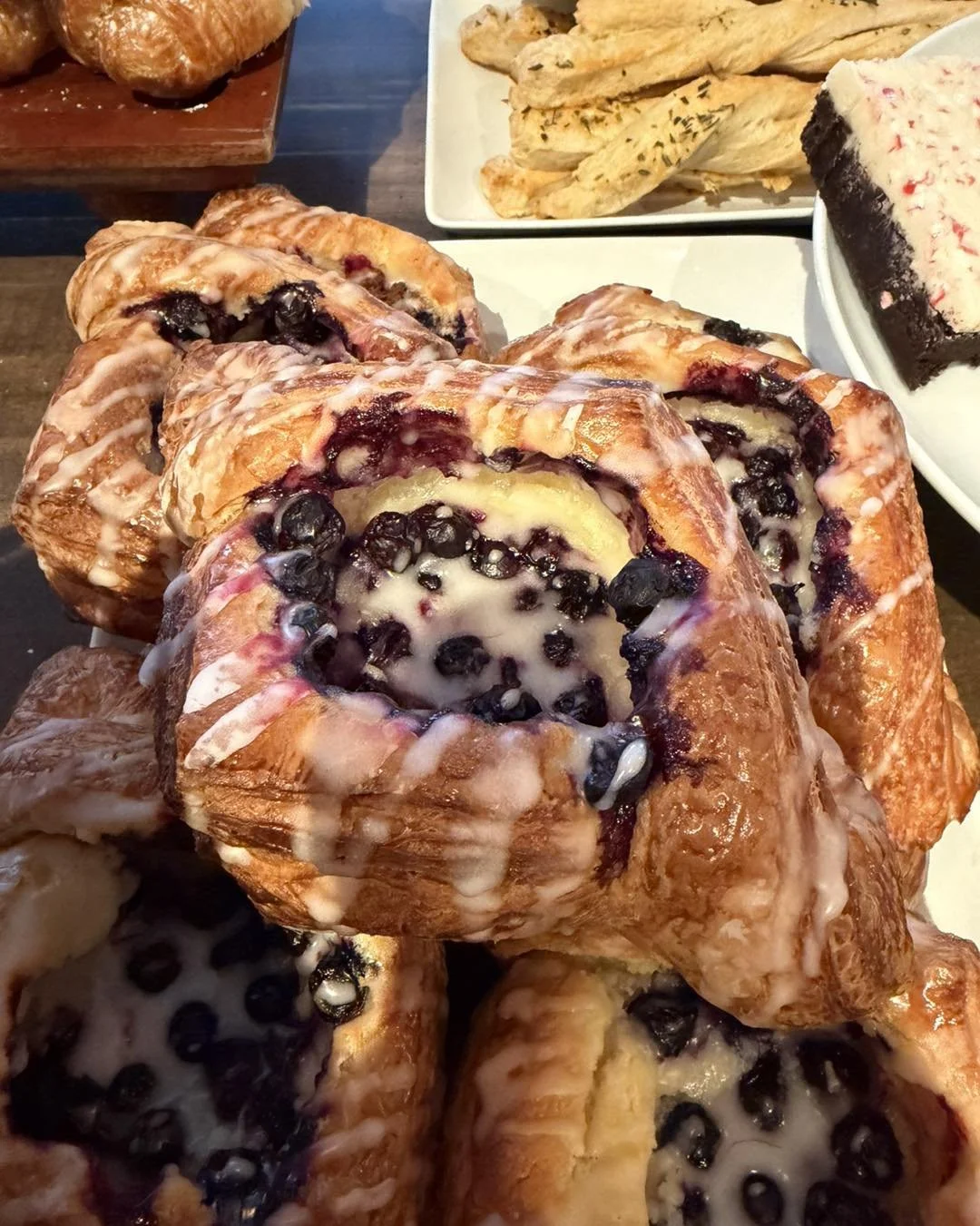 Close-up of blueberry cinnamon rolls with icing.
