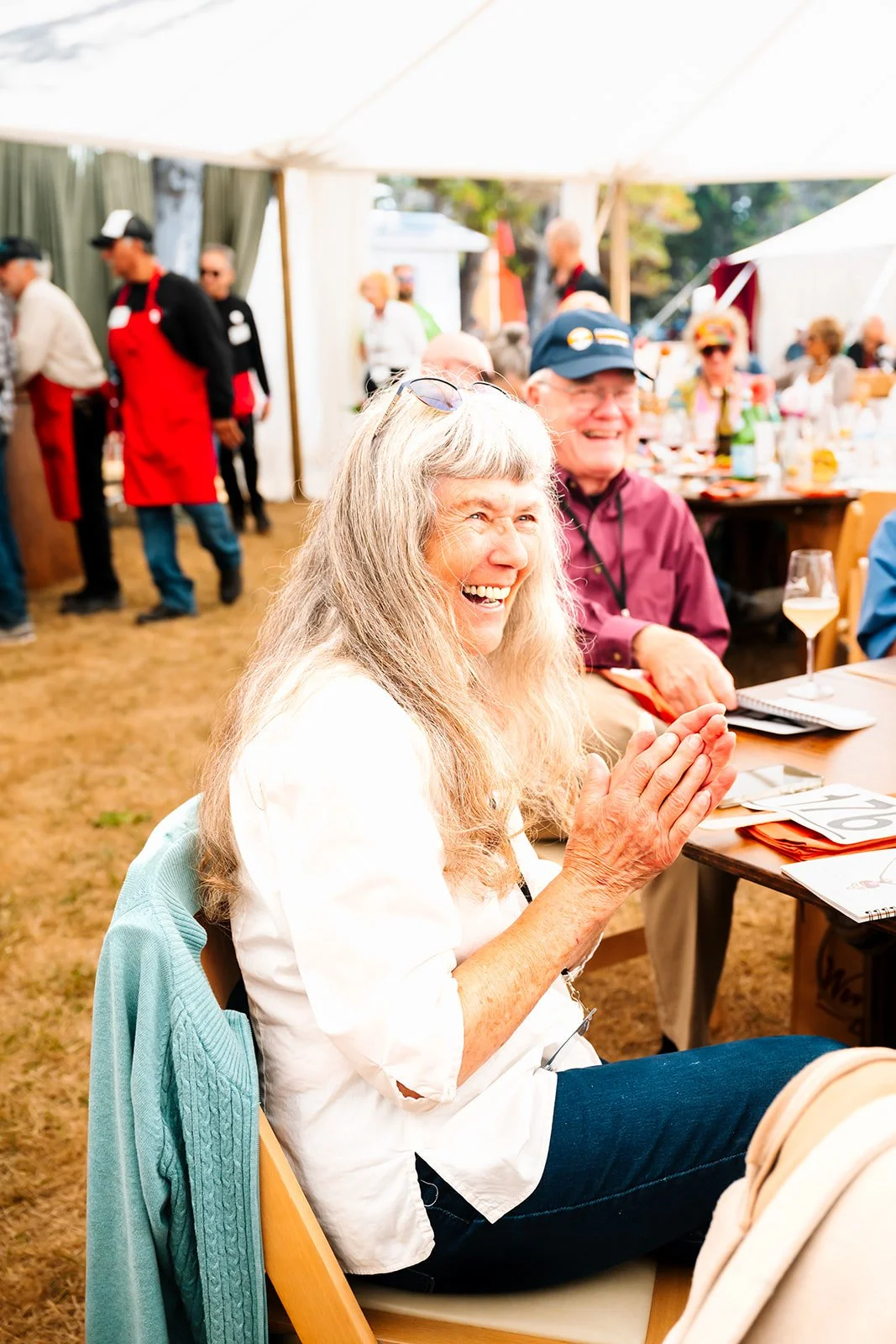 Charlene of Mendocino Coast Healthcare Foundation Board Member clapping at Winesong Live Auction at Winesong Wine Festival in Mendocino and Fort Bragg, California