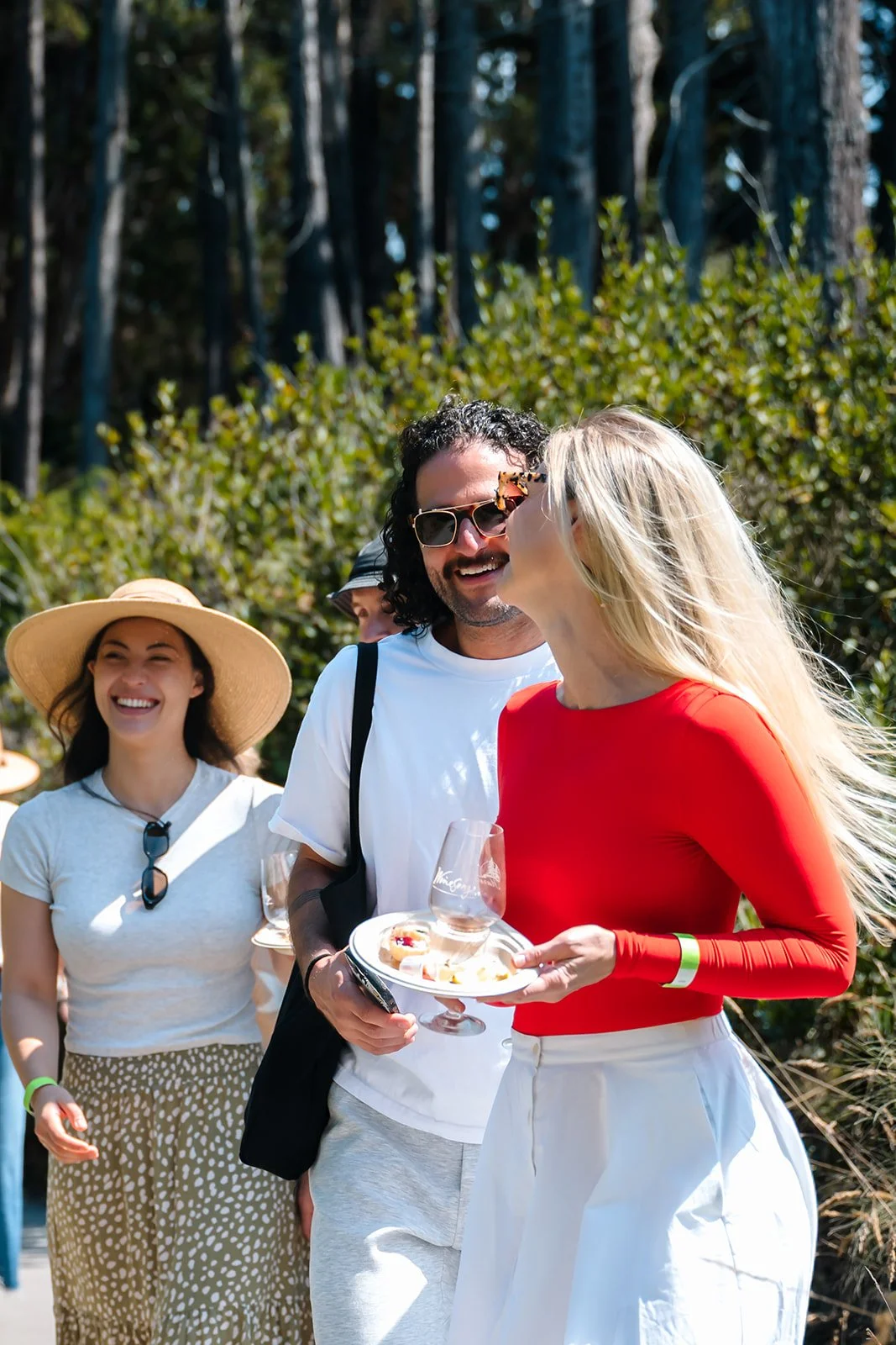 Three people laughing and talking at Winesong Wine Festival in Mendocino and Fort Bragg, California
