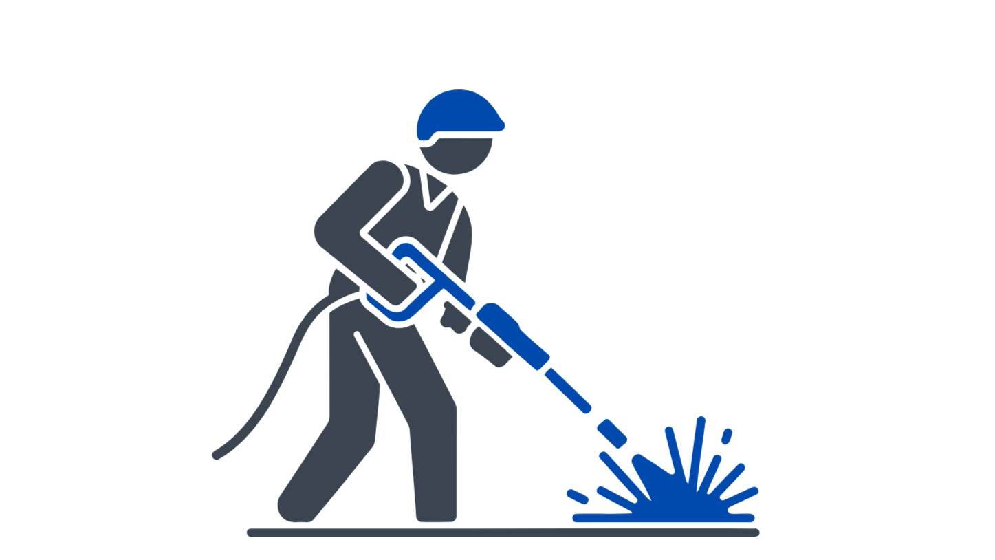 A person wearing safety gear operating a hot wire foam cutter, creating a foam sculpture or shape.