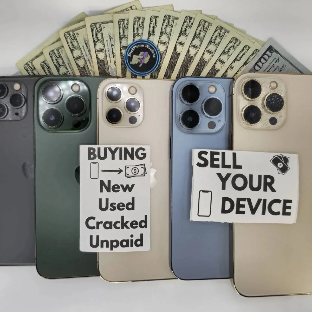 Four modern smartphones with camera lenses displayed, stacked with signs reading 'Buying New Used Cracked Unpaid' on the left phone and 'Sell Your Device' on the right phone. A fan of dollar bills and a badge that says 'Shell Phone Wireless' are at the top of the image.