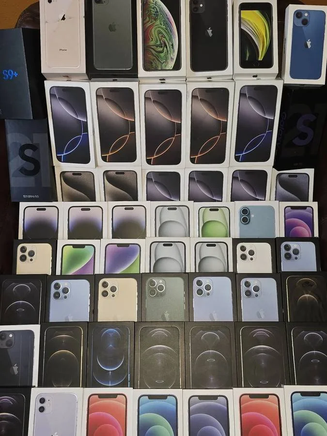 A large display of various iPhone models in their original boxes, arranged in rows and columns, showing different colors and designs.